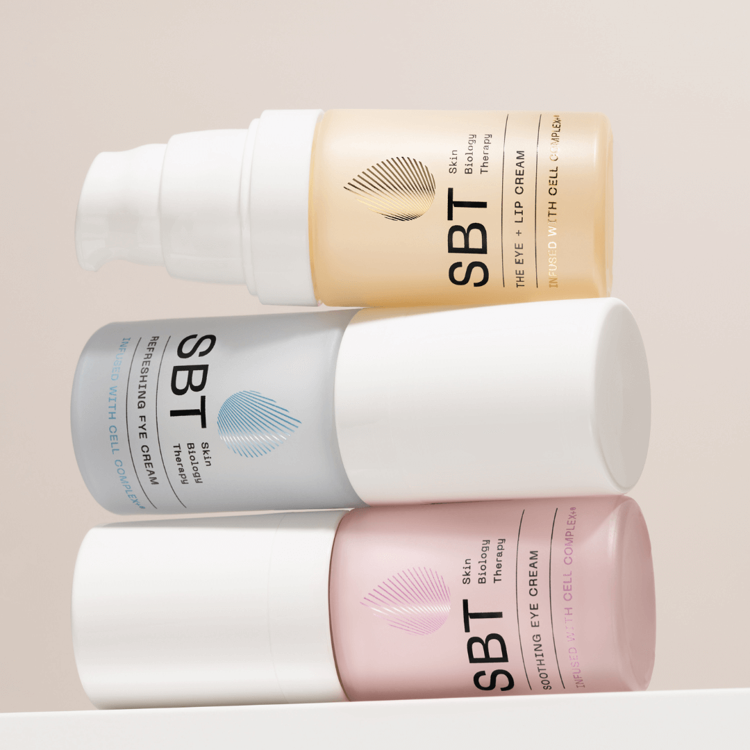 three SBT skincare bottles with beige background