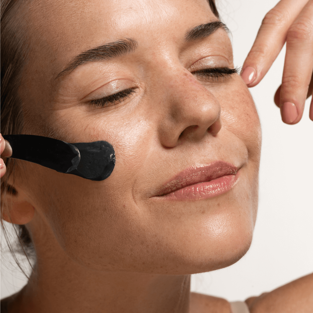 SBT applying clay mask on face