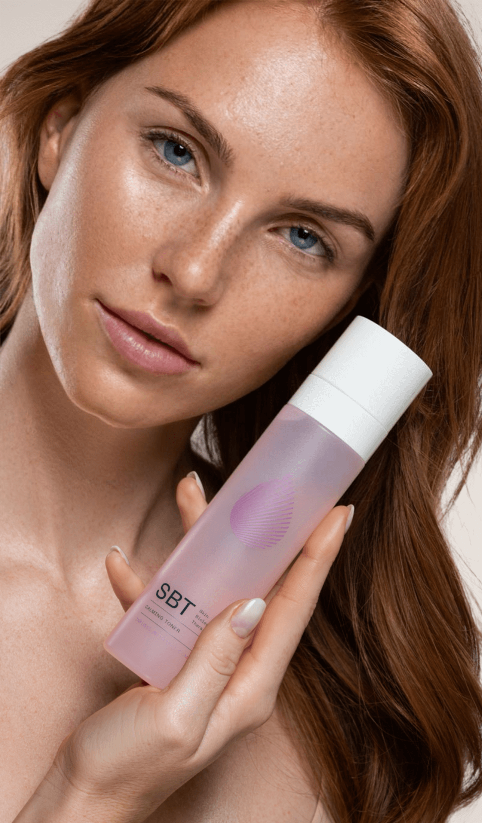 SBT Calming Toner women with product in hand