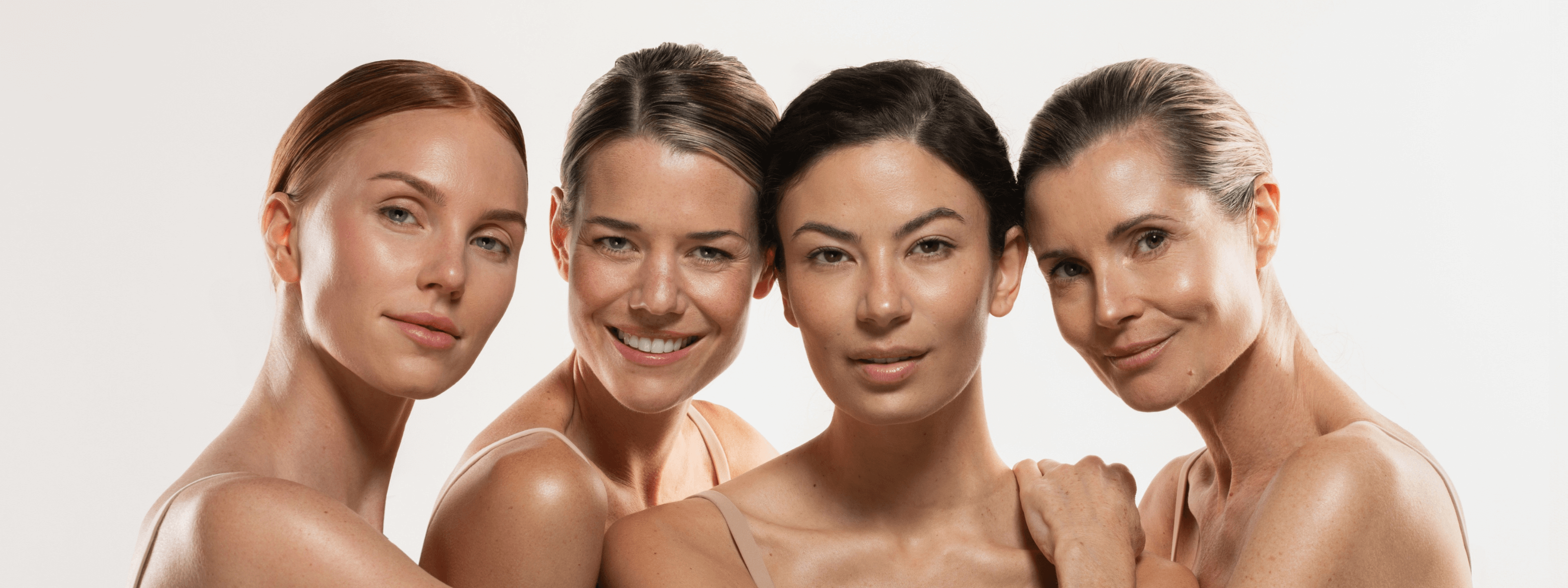 four women posing with beige background