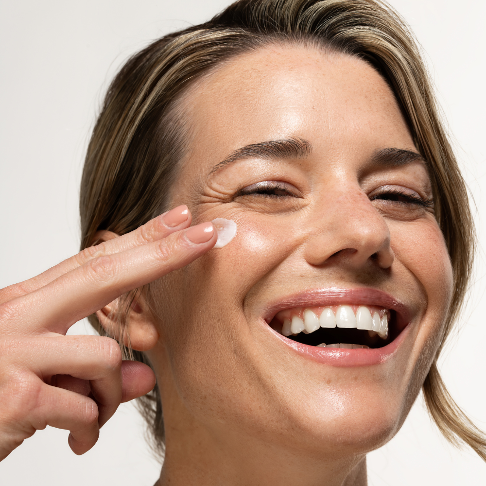 women applying lotion on face