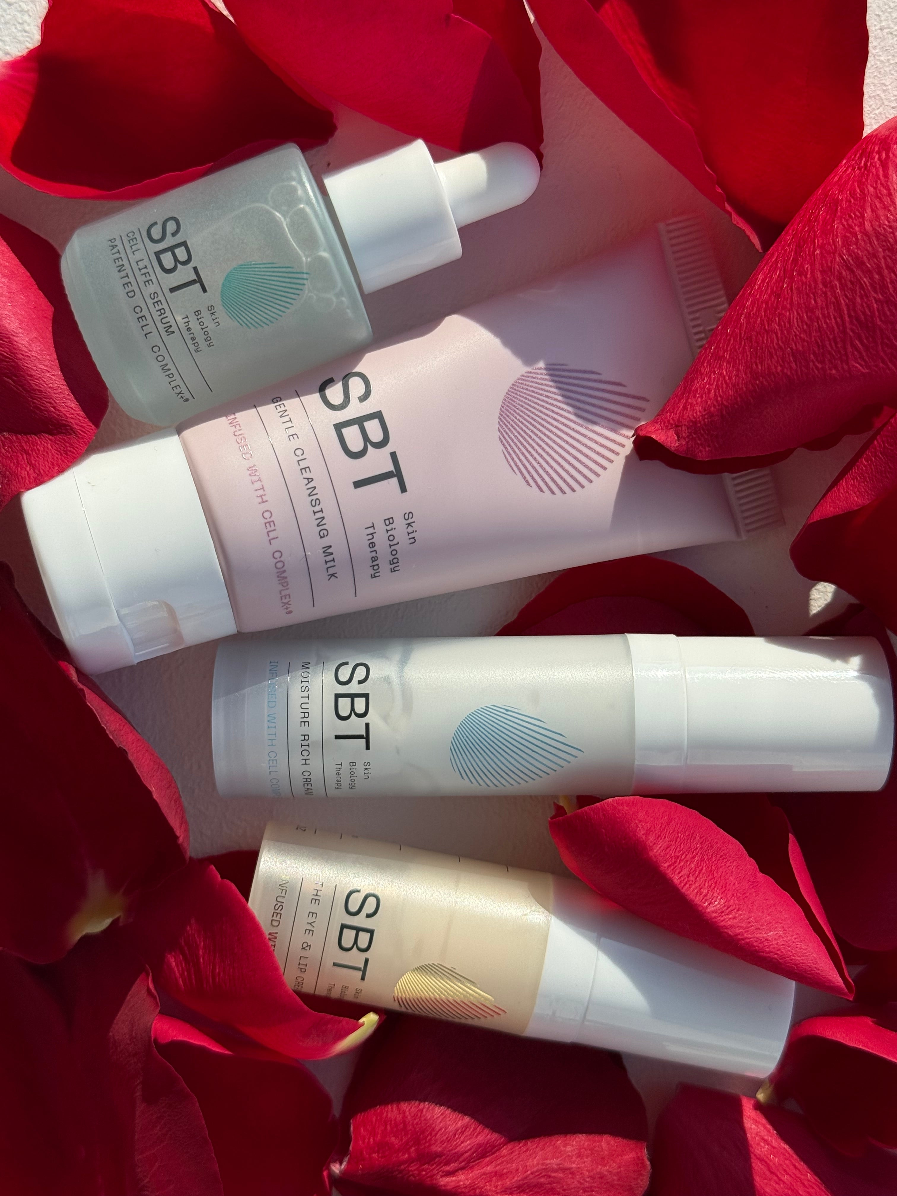 SBT skincare products on red floral background